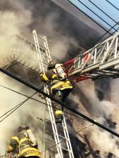 Andrew Serra, seen here as a firefighter battling a blaze in Staten Island in 2003 when he was with Squad 1 based in Park Slope, Brooklyn. Photo: FDNY