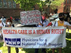 A group of Physicians for a National Health Program advocates at a recent demonstration. Photo courtesy of PNHP