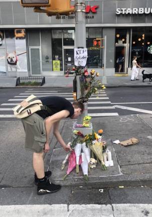 <b>Friends stopped by all weekend to lay flowers and candles and to reminesce about their friend Malcolm Livesey, who was killed June 16th while biking on First Ave near East. 17th St.</b> Photo: Keith J. Kelly