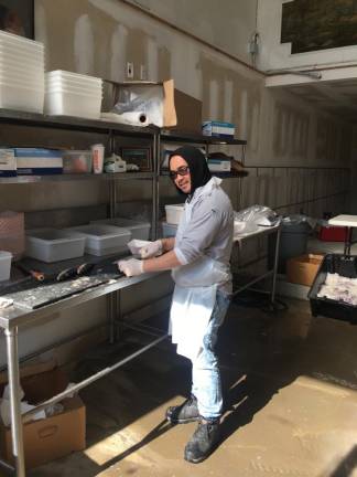 Michael Ibe working on the sardines at F. Rozzo and Sons seafood purveyors on Ninth Ave.