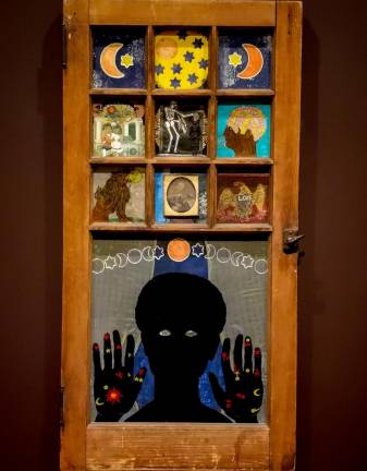 Betye Saar's Black Girl's Window, 1969, (wooden window frame with paint, cut-and-pasted printed and painted papers, daguerreotype, lenticular print, and plastic figurine) at The Museum of Modern Art.