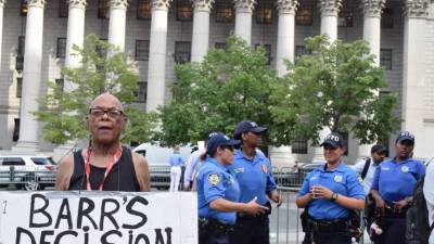 Police and a demonstrator at a July rally protesting the death of Eric Garner.