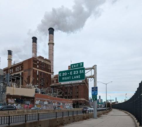 Runners and bikers on the East River Esplenade pass by the Con Ed power plant. Photo: Brian Berger