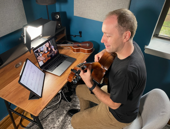 Damien Kelly teaches an online guitar lesson. Photo courtesy of Damien and Jessica Kelly