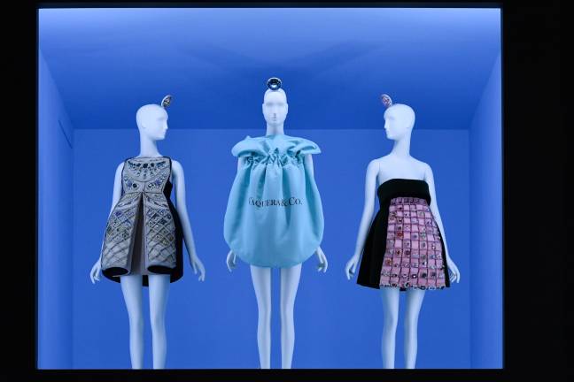 Gallery view of &quot;The Psychopathology of Affluence&quot;-themed fashions, featuring Vaquera's wearable Tiffany jewelry pouch, flanked by Mary Katrantzou's &quot;Harry Dress&quot; (left) and &quot;Winston Dress.&quot;&#xa0; Image courtesy of The Metropolitan Museum of Art, BFA.com/Zach Hilty