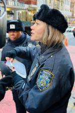 <b>NYPD Traffic Agent Maya Yilmaz activates a ticket to an illegally parked vehicle in a bus lane on West 57th Street. The ticketing is part of the enhanced bus lane Traffic Enforcement procedures that have been in place since Dec. 4.</b> Photo: Ralph Spielman