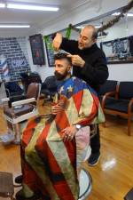 Barber Ari Jacobov with a client in his new shop. Photo: Deborah Fenker