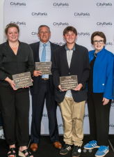 Jayden Howard (center), a Stuyvesant High School student, received the Billie Jean King Tennis Junior Achievement Award at an annual City Parks Foundation fundraiser. Pictured alongside him (left to right): Kim Clijster, Peter Hurley and Billie Jean King.