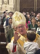 Cardinal Timothy Dolan blesses a youngster before the start of Easter Sunday Mass at St. Patrick’s Cathedral on April 20.