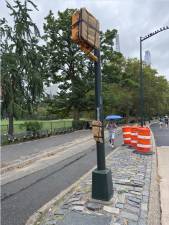 Traffic signals that would halt traffic and allow pedestrians to cross safely are wrapped in burlap and inoperable as part of a controversial pilot program that is redesigning the loop road in Central Park.