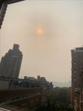 The sun–as seen on West 75th St looking toward the Hudson River on the afternoon of June 7th–is nearly totally blocked by the smokey haze caused by over 100 raging forest fires that are still burning in Canada. Photo: Michael Oreskes