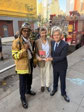 Author Michael Grynbaum (center) poses with Manhattan Borough President Brad Hoylman-Sigal and a firefighter on Sept. 15 after a fire erupted in the building where the Borough Book Club was going to feature the author’s new book, “Empire of the Elite” about the Condé Nastempire. He’s been rescheduled for Oct. 1 at a new location, Baruch College, 55 Lexington Ave.