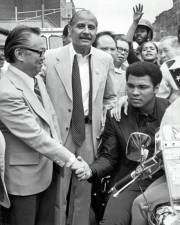 Muhammad Ali with Manhattan Borough President Percy Sutton (center) and M.B. Lee (left), President of the Chinese Consolidated Benevolent Association on “Muhammad Ali Day,” December 9, 1974. Photo: Emile Bocian, courtesy of The Museum of Chinese in America (MOCA)