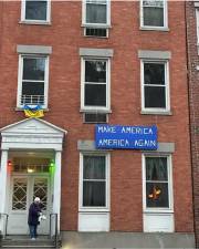 A sign on an apartment building downtown, address unknown. Note the Ukranian flag displayed outside one window.