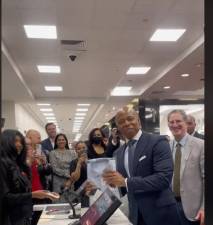 Eric Adams proudly holds up a dress shirt, the first purchase at the grand reopening of Century 21’s flagship store. Photo: TikTok, century21nyc.