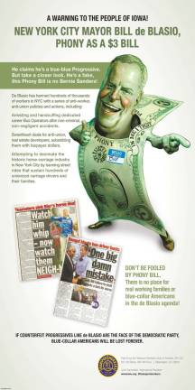 A mocking full-page ad in the Des Moines Register greeted Mayor Bill de Blasio upon his arrival in Iowa on December 19th to give a speech to a progressive advocacy group. Paid for by Local 100 of the Transport Workers Union, it was titled “A WARNING TO THE PEOPLE OF IOWA!” and branded him as “phony as a $3 bill.” Advertising graphic created by TWU / Local 100