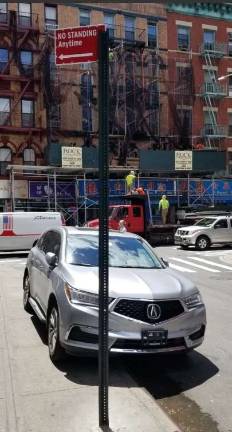 Illegally parked vehicles owned by city employees are a common sight on many Chinatown streets near City Hall and NYPD headquarters. Photo: @placardabuse, via Twitter.