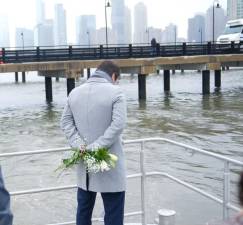 A devastated Joan Camprubi Montal, brother of Merce Camprubi Montal, prepares to toss flowers into the Hudson River near the site where his sister, her husband Agustin Escobar and their three children perished in a helicopter crash on April 10. The helicopter pilot was also killed in the crash.