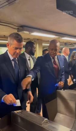Eric Adams shows Secretary of Transportation Sean Duffy how to swipe his card at a turnstile as he takes the Wisonsin-born Trump appointee on a two-stop “tour” of the nation’s largest subway system, which Duffy has termed a “shithole.”