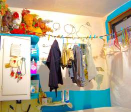 Clothes hang over the tub in an East Village apartment. The tenant has lived in the neighborhood since 1981.