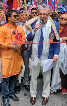 The Senator wears a “jazz hat,” or, more properly, a Nepalese “Dhaka topi.”