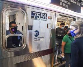 Interim New York City Transit President Sarah Feinberg greets a conductor at the 74 St-Broadway Station on the 7 line on opening day, May 8, 2020.