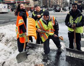 The work crew on Feb. 25 shoveling snow on the Upper East Side. Our intrepid reporter Heather Stein (left) was one of the few women on the job.