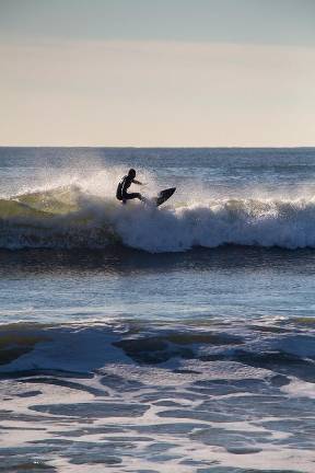 Surf conditions at Rockaway Beach change drastically from summer to winter, according to local surfers who say that colder weather generally brings more wind and choppier waves.