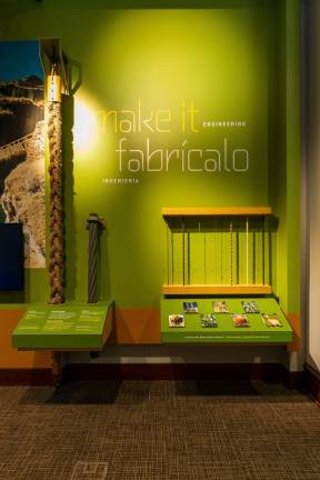 The "make it engineering" activity compares the strength of a steel cable from the Bayonne Bridge is on display next to a replica of the Q’eswachaka Bridge in Peru. Photo: 5th Ave Digital