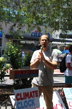 Gan Golan, Climate Clock co-creator and chief strategy officer, speaks to the crowd gathered in Union Square. Photo: Meryl Phair