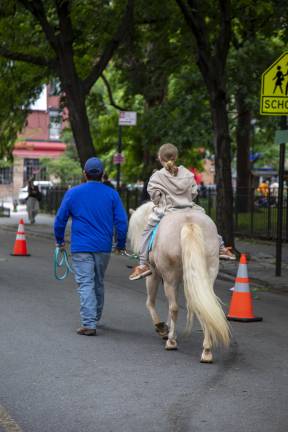Free pony rides were offered to children up to eight years old. Avenue B was closed off from 7th Street to 10th Street for enjoyment of the day’s activities. Children could ride a pony across 7th Street and Avenue B with guided assistance and limited traffic.