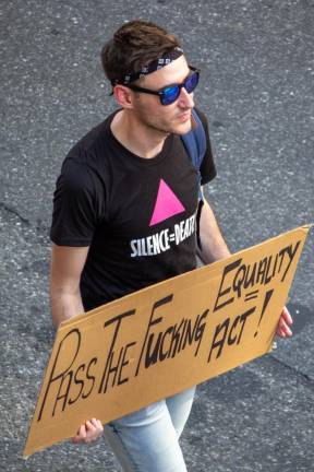 A marcher carries a pro-Equality Act sign. Photo: Trish Rooney