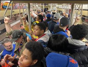 Fans on board a Redbird nostalgia train to Citi Field on Opening Day, April 4.