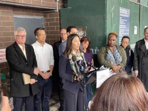 Assemblymember Grace Lee delivers a speech on Centre Street, outside of Chung Pak and the Manhattan Detention Complex demolition site, while surrounded by elected officials and community advocates.