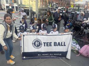 Tee ballers, barely bigger than the banner, get ready to step off at the start of the Opening Day parade for the Peter Stuyvesant Little League. There are still Tee ball openings for players living in the district between East 12th Street and East 72nd Street.