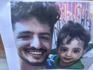 A photo of victim Abdul Saleh and his young son was taped to the RIP sign outside Sal’s Deli on E. 13th St. and Ave. B. He also had a young daughter.