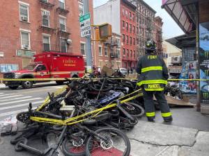 <b>Charred remains of e-bikes are stacked on the corner of Madison St. where the fire originated.</b> Photo: Carly Barovick