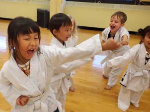 Kids living it up during karate time at a Super Happy Healthy Kids program.