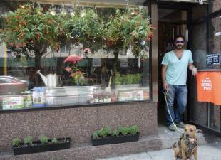 Nathaniel Garber Shoen, the great great grandson of the Russian immigrant who founded the original Garber’s Hardware story in 1884, stands at the doorway of the newest shop, a kitchen &amp; garden outlet on Ninth Ave. and 23rd. St with his pet “Kanga.” Photo: Deborah Fenker