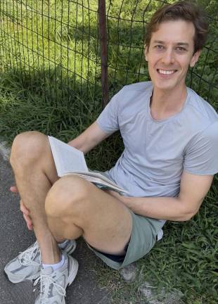 Florian, one of many “happy campers” on line in Central Park to score tickets for Shakespeare in the Park that evening.