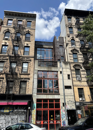 Though owner Eric Anderson has listed the property at 56 E. 1st St. for sale for nearly $10 million, the graffiti-tagged and concrete-stained panels may suggest why the property has lingered on Zillow for nearly seven years.