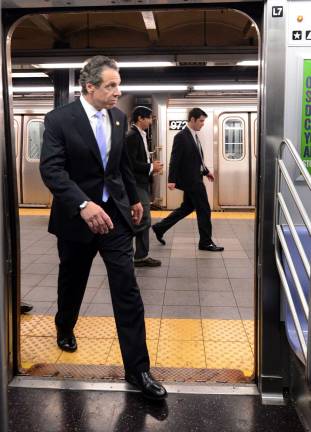Governor Andrew Cuomo boards an E train at Chambers Street for the ride to Penn Station in September 2014. Photo: Marc A. Hermann / MTA, via Wikimedia Commons  