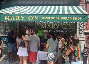 Long lines formed outside Mary O’s Irish Soda Bread Shop as owner Mary O’Halloran gave thanks to old and new friends with a free giveaway to each customer of two of her renowned scones. She urged customers to eat one and give the other away.