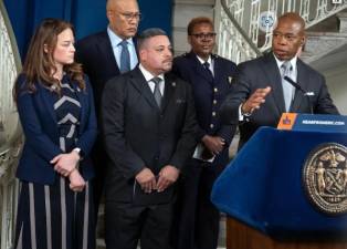 <b>Mayor Eric Adams (far right) is flanked by NYPD Commissioner Ed Caban (left of Adams) and FDNY Commisioner Laura Kavanagh (left) as he reveals on Jan. 10 that he is reversing previous cuts to the NYPD and FDNY. A day later, the Sanitation and Parks Departments also had some funds restored to programs. </b>