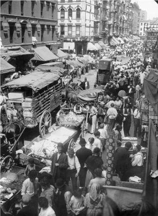 A jumble of pushcarts at odds with the grid, along Hester Street in 1903. The photograph portrays conditions that in the late 1930s led Mayor Fiorello LaGuardia to crack down on pushcarts and drive them off the streets. Photo via Wikimedia Commons