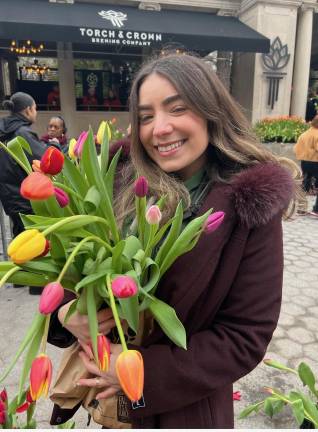 One of the estimated 15,000-plus attendees at Tulip Day 2025 in Union Square on March 30 who, under a gray, cloudy sky, picked up some bright spring flowers for free.