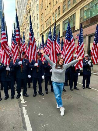 Everyone is Irish on St. Patrick’s Day. Leeza Koval, who said she is half Russian and half Ukranian, hangs with the FDNY as they form up on West 47th St. She turned and blew a kiss to the firefighters. Photo: courtesy Leeza Koval