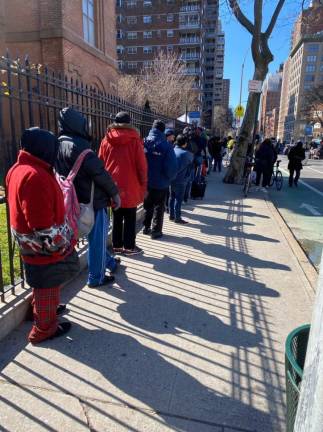 Guests line up outside for a hot meal or the food pantry at Holy Apostles Soup Kitchen, where they have seen a huge increase in demand. Photo courtesy of Holy Apostles Soup Kitchen.