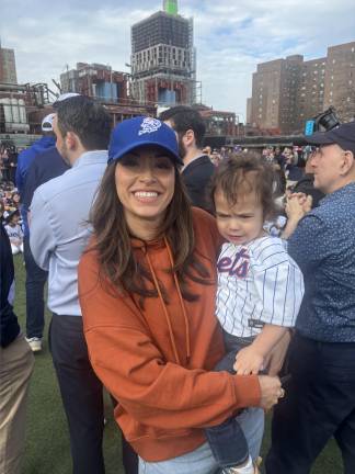 Politicians always enjoy opening day at the Peter Stuyvesant Little League. Council member Carlina Rivera holds her two-year-old son Benny. In back of her to the left is City Council member Keith Powers and to her right is Assembly member Alex Bores while Assembly member Harvey Epstein peeks over to the right.