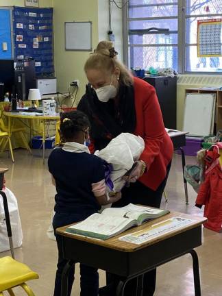 Manhattan Borough President Gale A. Brewer distributing gifts at PS 76 in Harlem from The Sled, a nonprofit providing assistance to underserved public school children. Photo: Gale A. Brewer on Twitter